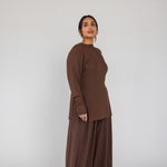 Woman wearing a brown outfit on a white background