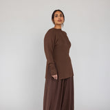 Woman wearing a brown outfit on a white background