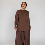 Woman wearing a brown outfit on a white background