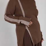 Brown top with truffle accents worn by a person on a white background