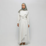 Woman wearing a white dress with a belt and a gray hijab on a white background