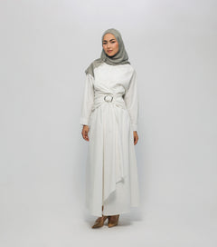 Woman wearing a white dress with a belt and a gray hijab on a white background