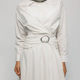 White dress with a belt and hijab on a plain background