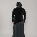 Person wearing a black dress on a white background