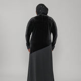 Person wearing a black dress on a white background