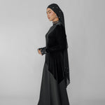 Woman wearing a black dress on a gray background