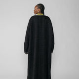 Person wearing a black abaya on a white background