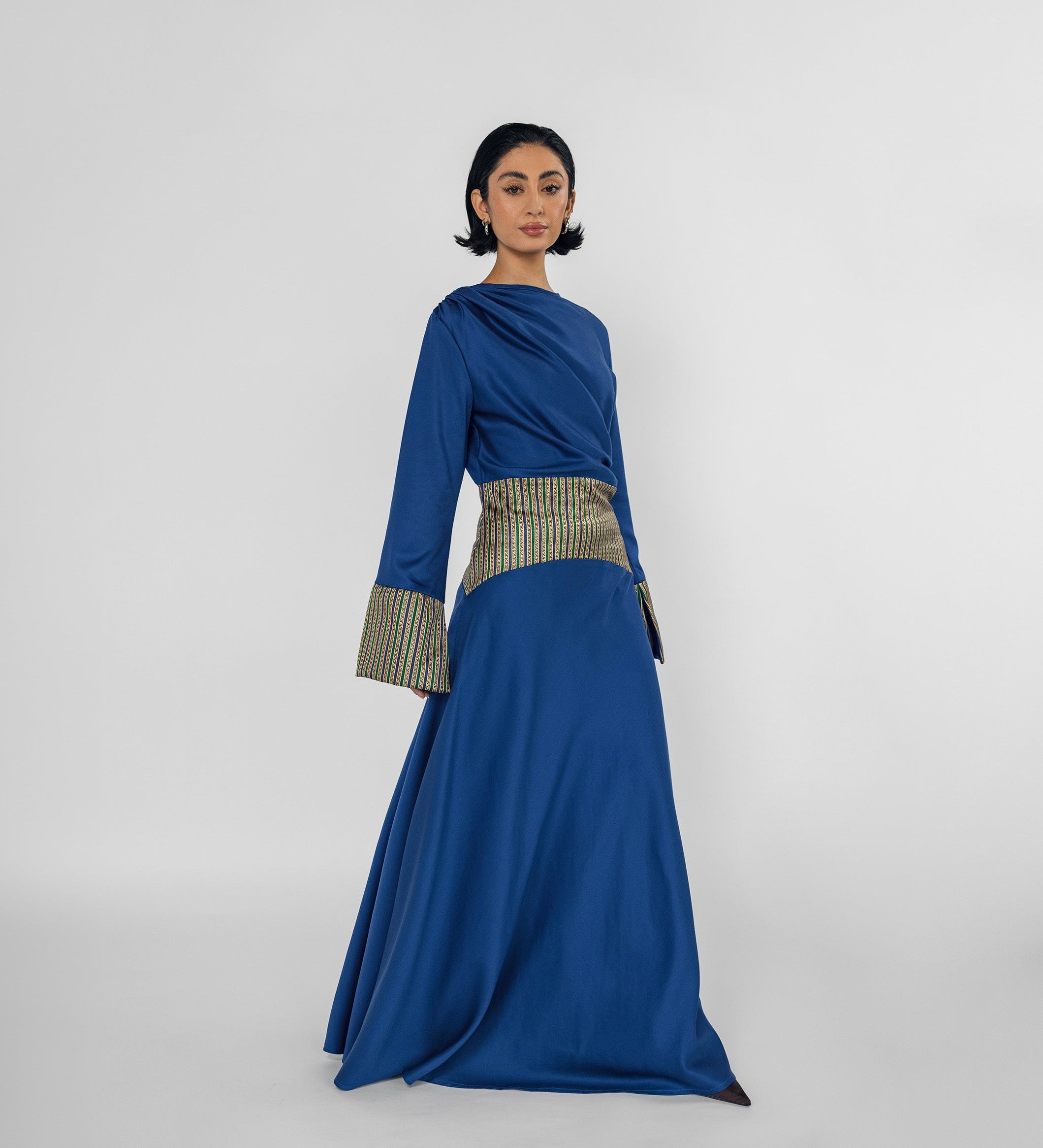 Woman wearing a blue dress with a white background