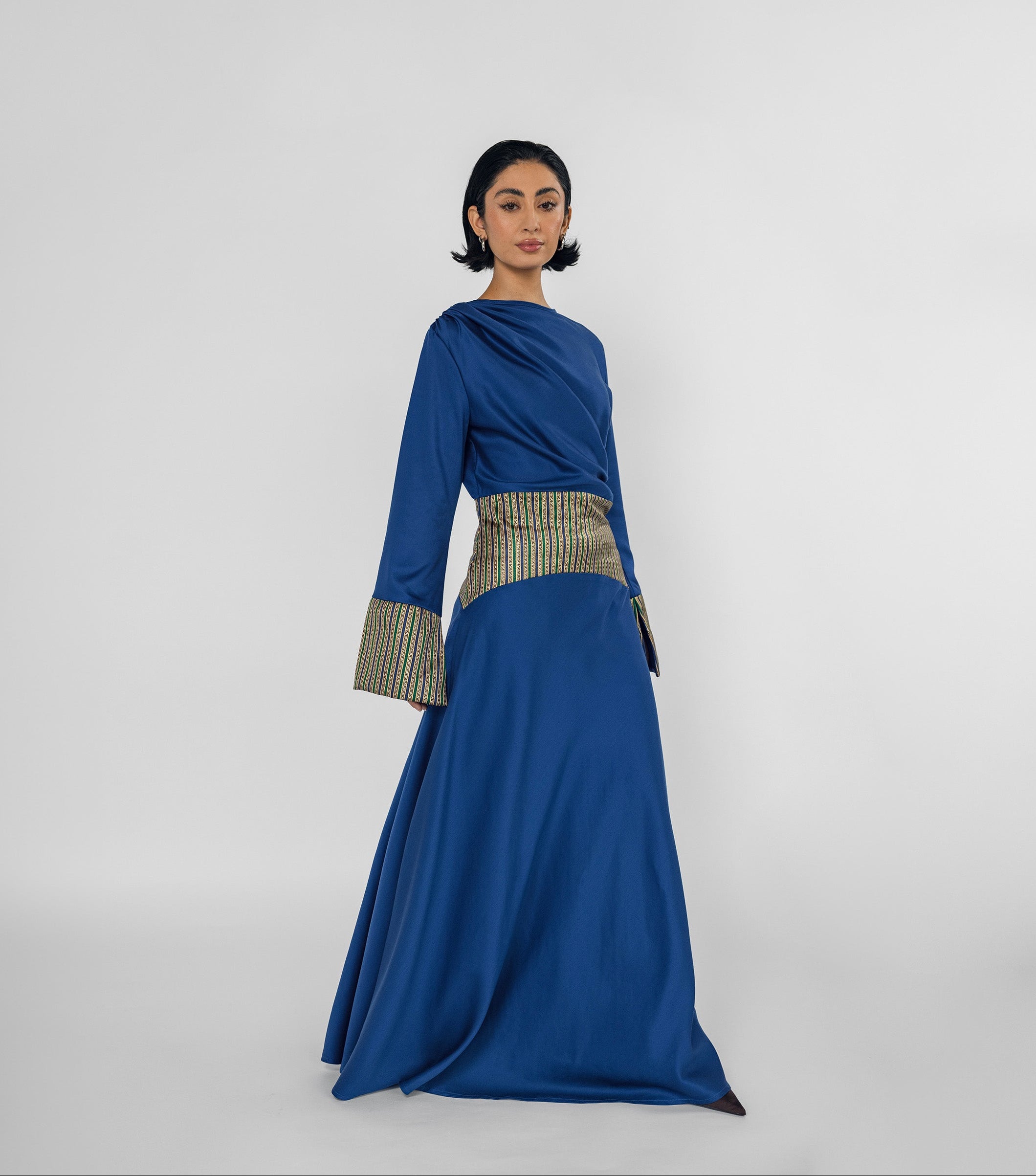 Woman wearing a blue dress with a white background