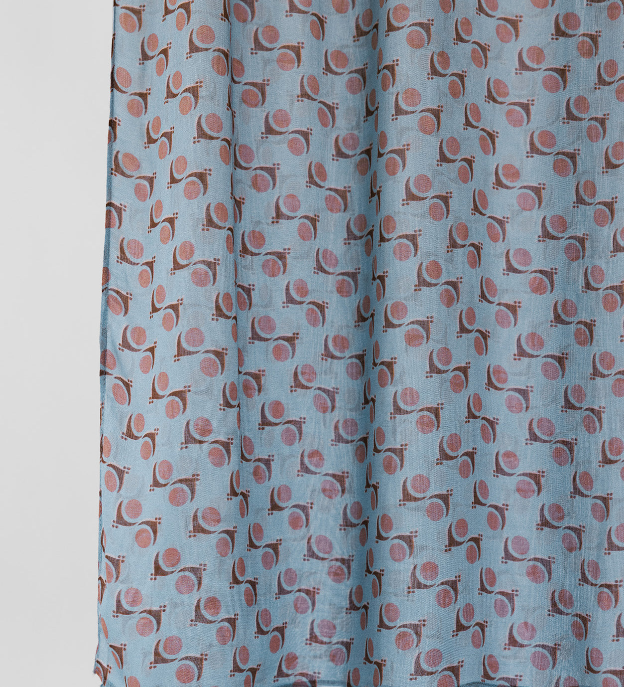 Fabric with a pattern of small shapes on a light blue background