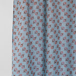 Fabric with a pattern of small shapes on a light blue background