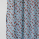 Fabric with a pattern of small shapes on a light blue background