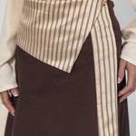Brown skirt with a striped detail worn by a person on a plain background