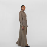 Woman wearing a brown suit with a white background