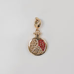 Gold pomegranate charm with red detailing.  