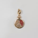 Gold pomegranate charm with red detailing.  