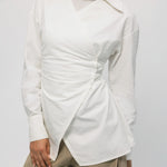 White blouse with a unique design on a plain background