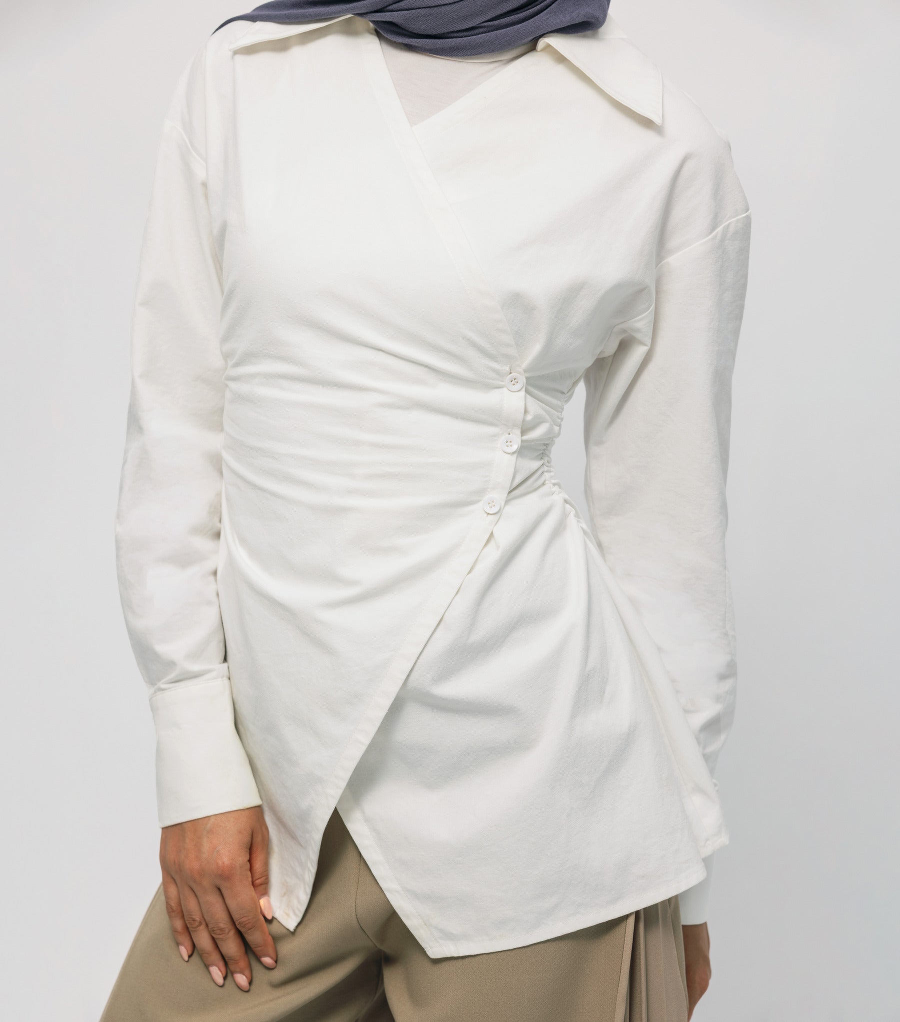 White blouse with a unique design on a plain background
