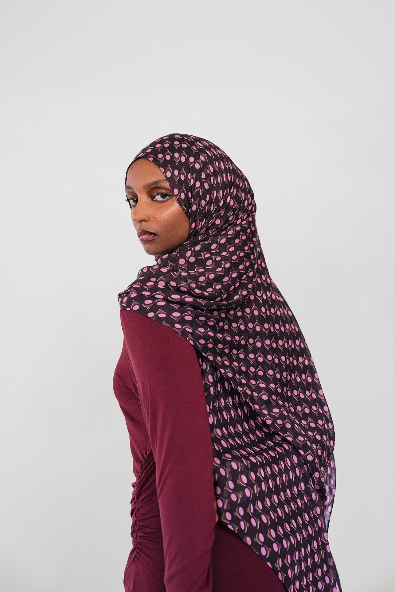Woman wearing cocoa eclipse hijab on white background