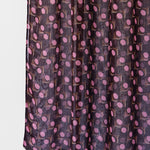Dark purple fabric with pink polka dot pattern on a white background