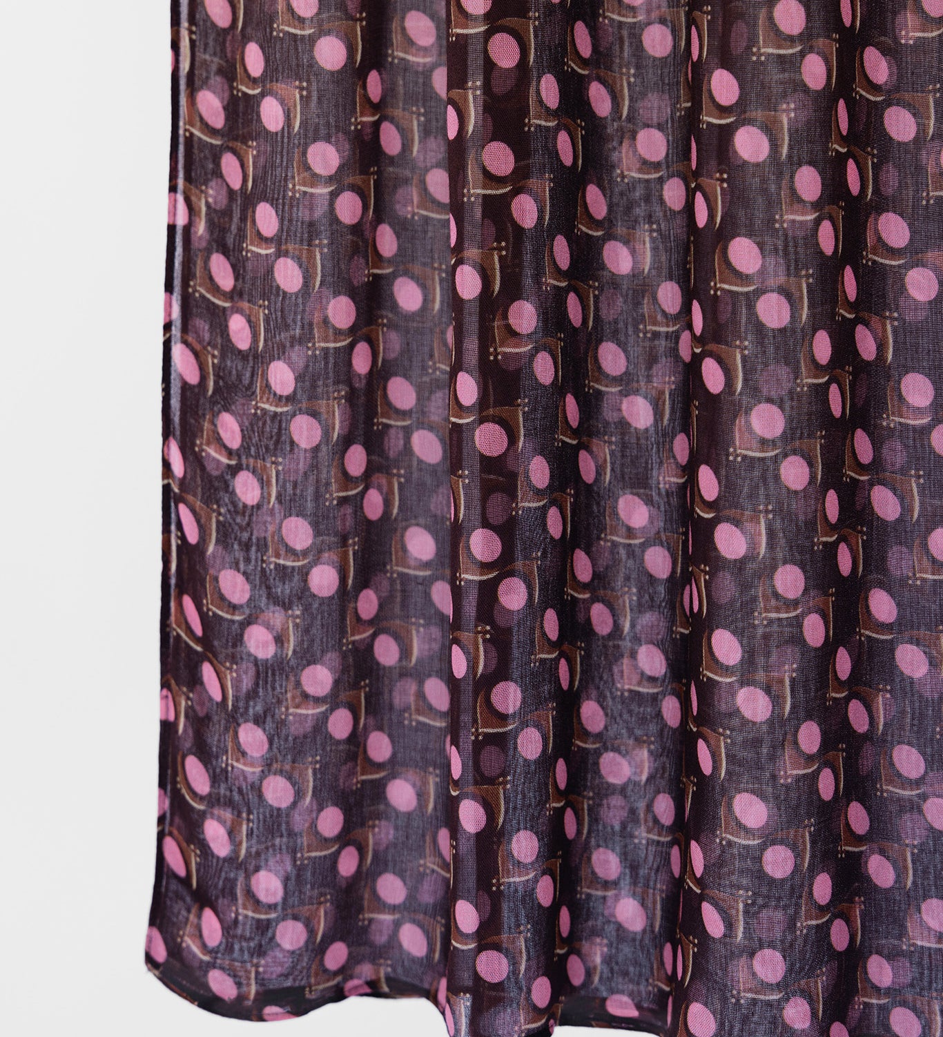 Dark purple fabric with pink polka dot pattern on a white background