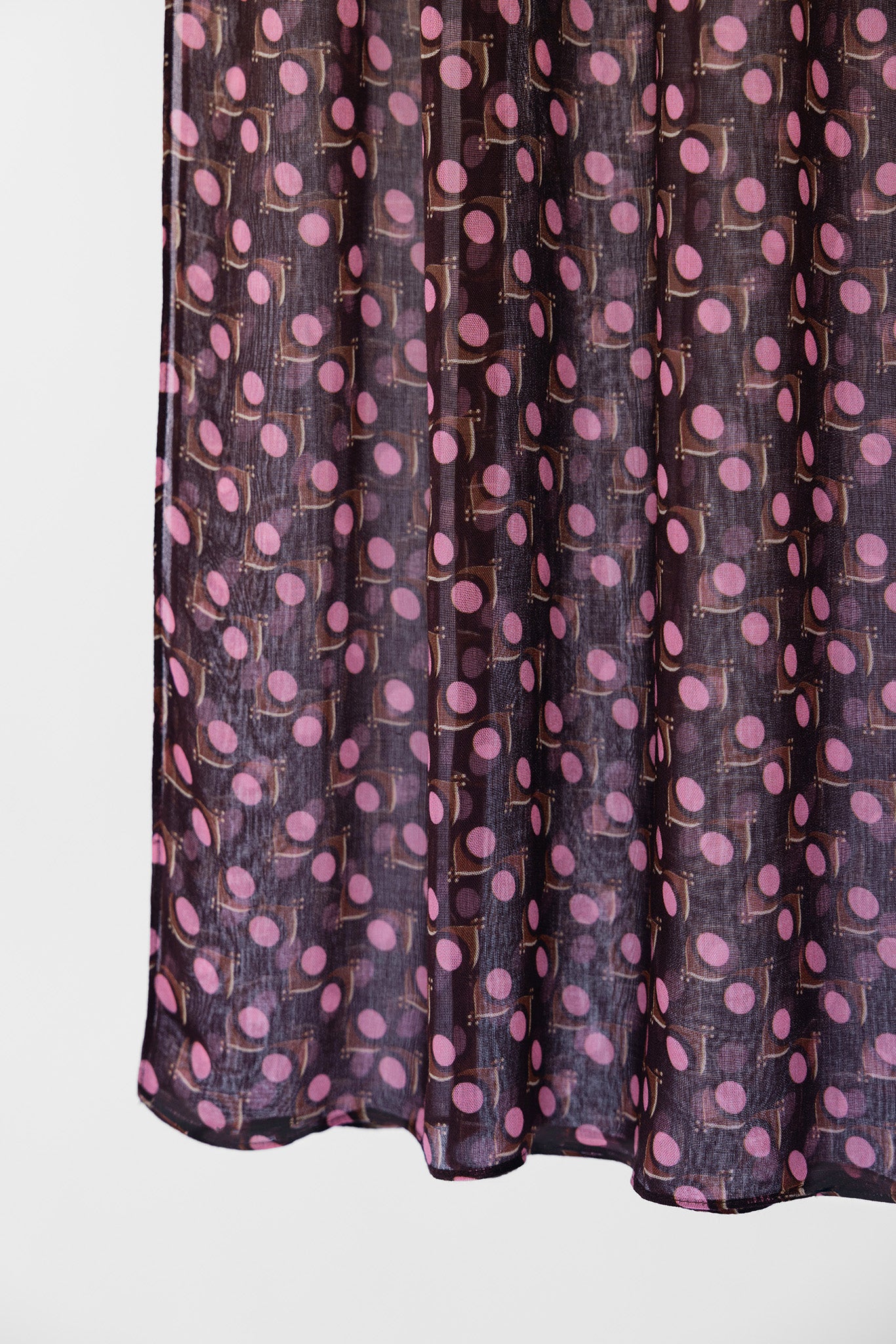 Dark purple fabric with pink polka dot pattern on a white background