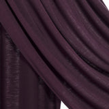 A close-up of draped dark plum purple fabric with a subtle sheen, showing the texture and folds against a white background.