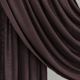 Close-up of a draped brown fabric against a neutral background