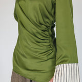 Green long-sleeve top with a ruched design on a plain background