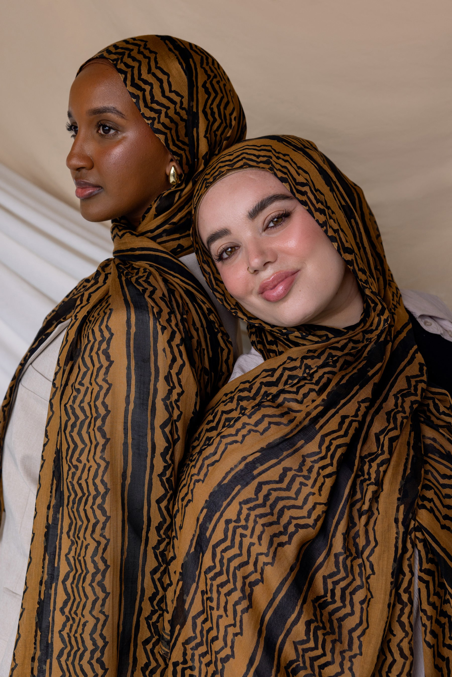 Two Models wearing woven hijab featuring a heritage-inspired print in a modern, watercolor finish.


