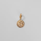 Gold Henna Charm on a light gray background