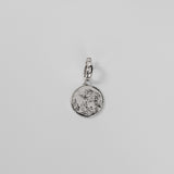 Silver Henna Charm on a light gray background