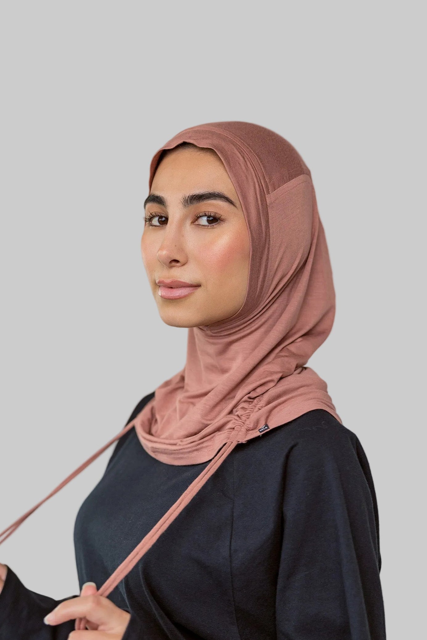 Model wearing Terra Blush Ruching Lite, showing warm pink hue styled in the unruched way.