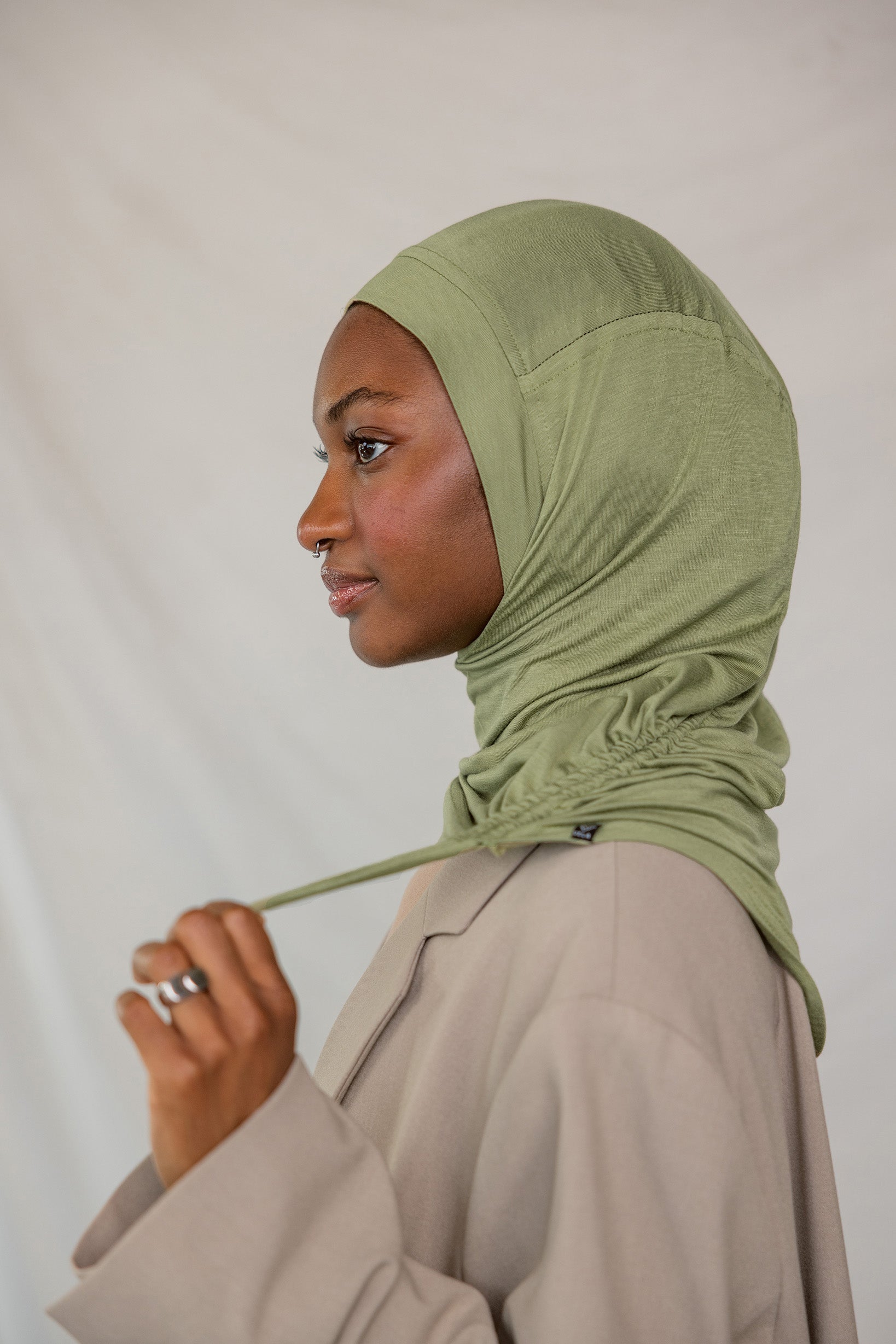 Model wearing Palm Desert Ruching Lite, showing ruching texture and breathable, wrinkle-free fabric.