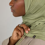 Model wearing Palm Desert Ruching Lite, highlighting earthy olive tone and soft ruching.
