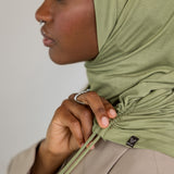Model wearing Palm Desert Ruching Lite, highlighting earthy olive tone and soft ruching.