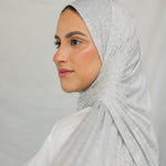 Close-up image of model wearing Marble Grey Jersey Lite draped neatly. 