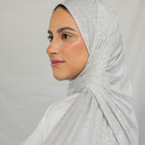 Close-up image of model wearing Marble Grey Jersey Lite draped neatly. 