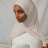 Model wearing Ashwood Jersey Lite in a loose front wrap, showing its versatile neutral hue and stretch.