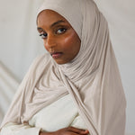 Model wearing Ashwood Jersey Lite in a loose front wrap, showing its versatile neutral hue and wrinkle-resistant drape.