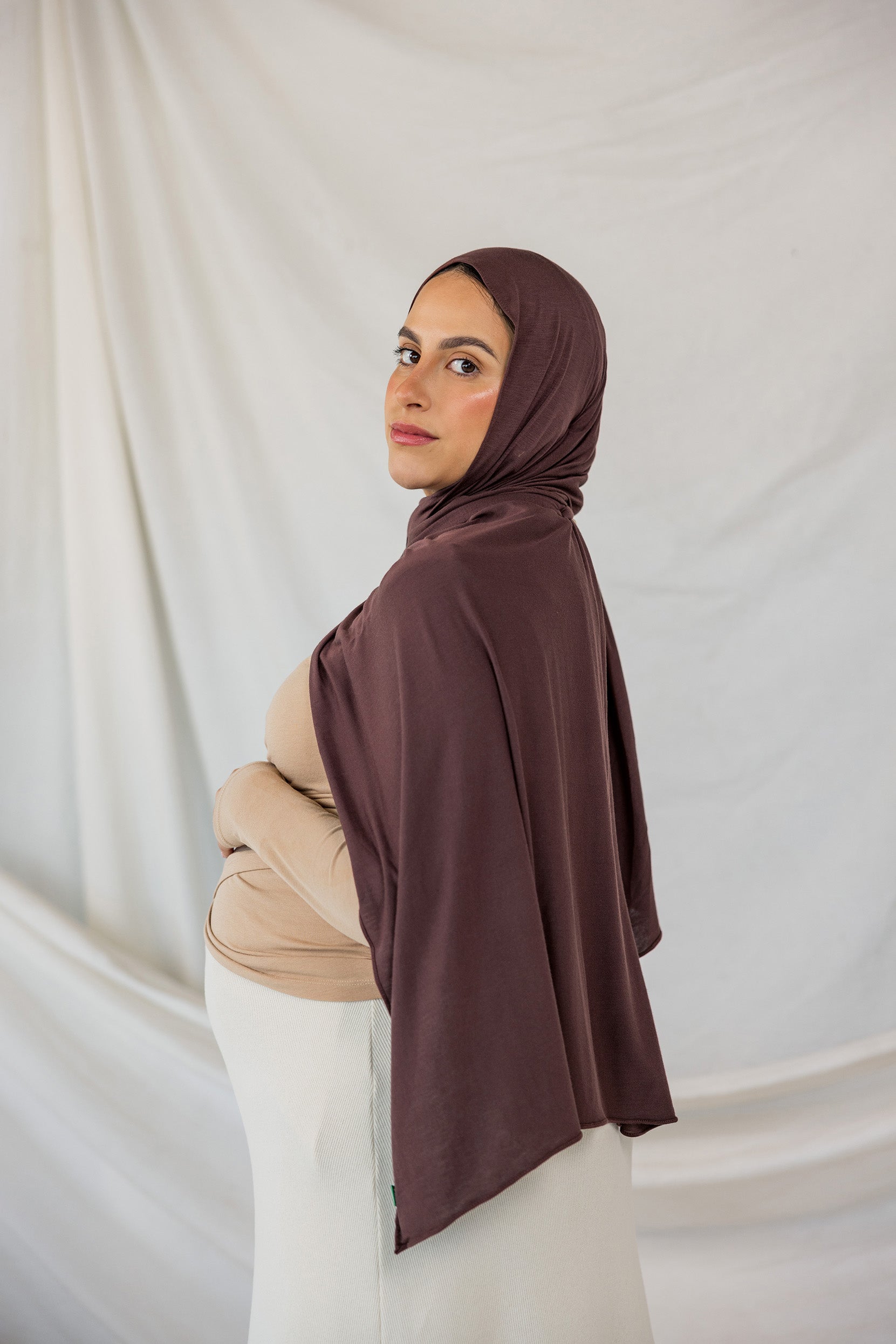 Expecting model looks over her shoulder wearing the Espresso Jersey Lite in standard. 
