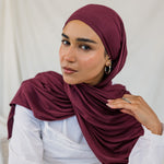 Model wearing Antique Cherry Jersey Lite in a relaxed wrap style, highlighting its deep, berry tone. 