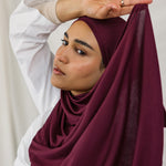 Model wearing Antique Cherry Jersey Lite in a relaxed wrap style, highlighting its deep, bold tone and wrinkle-free look.