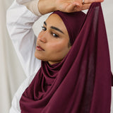 Model wearing Antique Cherry Jersey Lite in a relaxed wrap style, highlighting its deep, bold tone and wrinkle-free look.