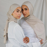  Two models wearing Ashwood Jersey Lite, highlighting its warm beige tone in different wrap styles.