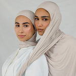 Two models wearing Ashwood Jersey Lite, highlighting its warm beige tone and flex fabric. 