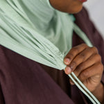 Close-up view of the Sage Mist Ruching Lite hijab depicting the model using the ruching strings. 