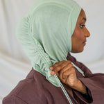 Model wearing Sage Mist Ruching Lite, highlighting minty sage tone and texture.