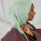 Model wearing Sage Mist Ruching Lite, highlighting minty sage tone and texture.