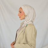 Model wearing Ashwood Ruching Lite fabric draped against white backdrop, revealing beige-ash tone and ruched design.